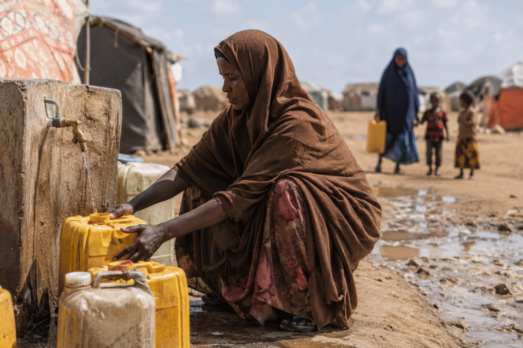 Somali woman collecting water due to limited access to safe drinking water.